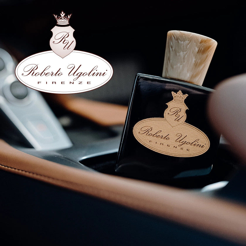Parfumflakon „Derby EdP“ von „Roberto Ugolini“ in der Mittelkonsole eines Autos.